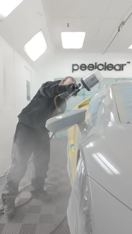 Spray gun closeup in booth