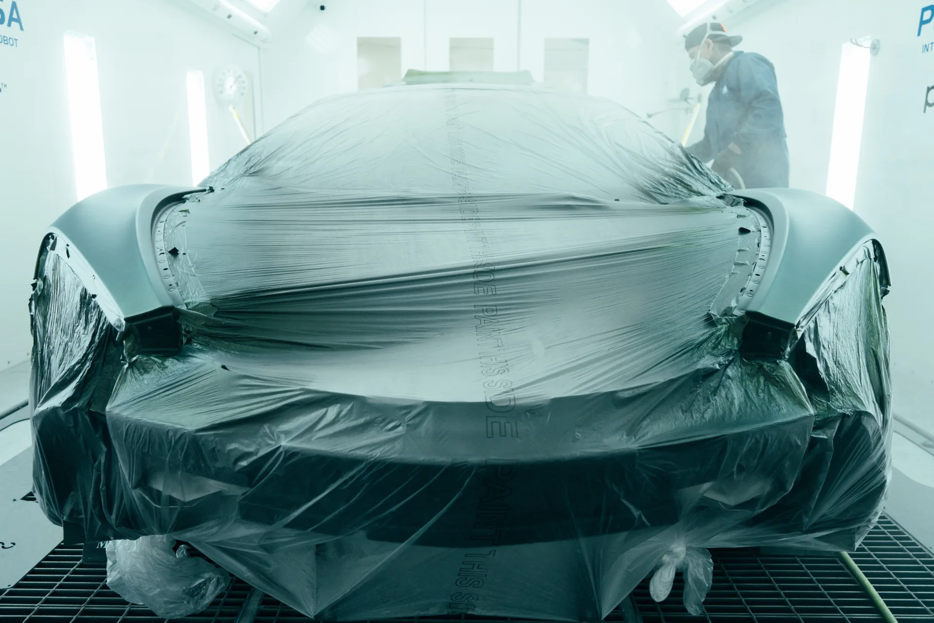 Car being sprayed in Peelclear booth